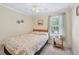 A well-lit bedroom featuring a comfy bed, ceiling fan, and a window, creating a relaxing and inviting space at 645 Camp Perrin Rd, Lawrenceville, GA 30043
