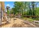 A spacious wooden deck offering outdoor relaxation and entertainment space, surrounded by a lush green yard at 645 Camp Perrin Rd, Lawrenceville, GA 30043