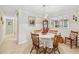 A cozy dining room with bright, neutral walls, a chandelier, and a round dining table for intimate meals at 645 Camp Perrin Rd, Lawrenceville, GA 30043