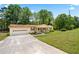 Wide angle of a charming one-story home with front porch, attached garage and lush green lawn at 645 Camp Perrin Rd, Lawrenceville, GA 30043