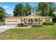Charming one-story home features a welcoming front porch and attached garage, nestled on a lush green lawn at 645 Camp Perrin Rd, Lawrenceville, GA 30043