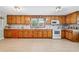 Spacious kitchen featuring wood cabinets, white appliances, and plenty of counter space at 645 Camp Perrin Rd, Lawrenceville, GA 30043