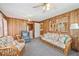 Bright sunroom with wood-paneled walls, multiple windows, and comfortable seating arrangements at 645 Camp Perrin Rd, Lawrenceville, GA 30043