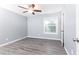 A calming bedroom features gray walls, laminate flooring, and a window offering natural light at 725 Dalrymple Rd # 3G, Atlanta, GA 30328
