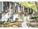 Charming townhouse exterior with a walkway, balconies, and lush landscaping at 725 Dalrymple Rd # 3G, Atlanta, GA 30328