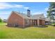Brick home featuring a well-maintained lawn and view of rear elevation at 8495 Spivey Village Way, Jonesboro, GA 30236