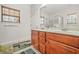 Bathroom features a double sink vanity, framed mirror, and a window providing natural light at 8495 Spivey Village Way, Jonesboro, GA 30236