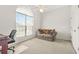 Bright bedroom with a large arched window, plush carpeting, and a comfortable seating area at 8495 Spivey Village Way, Jonesboro, GA 30236