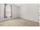 Empty bedroom featuring neutral carpet, a window with patterned curtains, and ample natural light at 8495 Spivey Village Way, Jonesboro, GA 30236