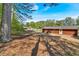 Rear exterior showcasing the home's backyard, mature trees and ample space for outdoor activities at 3393 Ridgecrest Dr, Powder Springs, GA 30127