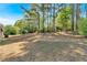 Expansive backyard surrounded by towering trees, providing shade and privacy for outdoor enjoyment at 3393 Ridgecrest Dr, Powder Springs, GA 30127
