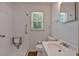Clean bathroom featuring a walk-in shower, white vanity, toilet and accessible features at 3393 Ridgecrest Dr, Powder Springs, GA 30127