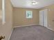Empty bedroom with neutral walls, carpeted floor, window, closet, and a ceiling light at 3393 Ridgecrest Dr, Powder Springs, GA 30127