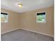 Empty bedroom with neutral walls, carpeted floor, and two windows with outside view at 3393 Ridgecrest Dr, Powder Springs, GA 30127