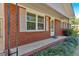 Charming brick home exterior featuring a covered porch and manicured landscaping at 3393 Ridgecrest Dr, Powder Springs, GA 30127