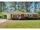 Charming brick ranch-style home featuring a carport and a well-maintained lawn at 3393 Ridgecrest Dr, Powder Springs, GA 30127