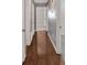 Inviting hallway with gleaming wood floors and neutral walls, offering a seamless transition between rooms at 3393 Ridgecrest Dr, Powder Springs, GA 30127