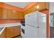 Kitchen featuring wooden cabinets, countertops, microwave, oven/stove, and a white refrigerator at 3393 Ridgecrest Dr, Powder Springs, GA 30127