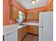 Kitchen featuring wooden cabinets, countertops with sink and dishwasher, plus a white refrigerator at 3393 Ridgecrest Dr, Powder Springs, GA 30127
