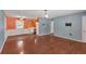 Open living room leading to the kitchen, featuring hardwood floors and a modern light fixture at 3393 Ridgecrest Dr, Powder Springs, GA 30127