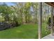 Beautiful backyard view with a swing and an expansive green lawn surrounded by trees at 6050 Providence Ln, Cumming, GA 30040