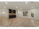 Large basement with tile flooring, a wet bar with built-in cabinetry, and a window overlooking the yard at 6050 Providence Ln, Cumming, GA 30040