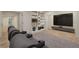 Basement living space with theater seating, tile floors, built-in bookshelves, and a large screen TV at 6050 Providence Ln, Cumming, GA 30040