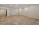 Expansive basement space featuring neutral tile flooring, crisp white trim, and recessed lighting at 6050 Providence Ln, Cumming, GA 30040