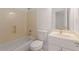 Bathroom with a tub, toilet, and a vanity with white cabinets and a framed mirror above at 6050 Providence Ln, Cumming, GA 30040