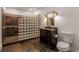 Well-lit bathroom featuring a glass-block shower and dark wood vanity with a granite countertop at 6050 Providence Ln, Cumming, GA 30040