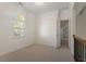 Bedroom with neutral carpet, light walls, trim, and a large window with an arched transom at 6050 Providence Ln, Cumming, GA 30040