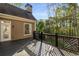 Back deck with decorative wood railings, wood flooring, and a view of the wooded backyard at 6050 Providence Ln, Cumming, GA 30040