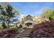 Stunning exterior of home with landscaped yard, stone staircase, and charming porch at 6050 Providence Ln, Cumming, GA 30040
