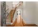 Grand foyer with hardwood floors, staircase, and an arched doorway leading to the living area at 6050 Providence Ln, Cumming, GA 30040