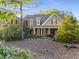 Charming two-story home with a covered front porch, manicured landscaping, and beautiful curb appeal at 6050 Providence Ln, Cumming, GA 30040