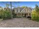 Charming two-story home with a covered front porch and manicured landscaping creates excellent curb appeal at 6050 Providence Ln, Cumming, GA 30040
