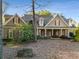 Two-story home with shutters, dormer windows, landscaped yard and covered front porch at 6050 Providence Ln, Cumming, GA 30040
