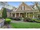 Charming two-story home with a covered front porch and manicured landscaping leads to excellent curb appeal at 6050 Providence Ln, Cumming, GA 30040