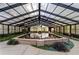 Breathtaking indoor pool with lush plants and natural light from glass ceilings at 6050 Providence Ln, Cumming, GA 30040