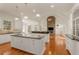 Open kitchen with white cabinets, granite countertops, double islands, and a stone fireplace at 6050 Providence Ln, Cumming, GA 30040