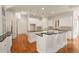 Spacious kitchen with white cabinetry, dual islands, granite counters, and stainless steel appliances at 6050 Providence Ln, Cumming, GA 30040