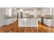 Bright kitchen showcasing white cabinetry, granite countertops, and a large center island at 6050 Providence Ln, Cumming, GA 30040