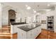 Modern kitchen with double islands, stone fireplace, stainless steel appliances and vaulted ceilings at 6050 Providence Ln, Cumming, GA 30040
