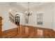 Bright living room featuring hardwood floors, large windows, a chandelier, and coffered ceilings at 6050 Providence Ln, Cumming, GA 30040