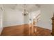 Spacious living room with hardwood floors, wainscoting, coffered ceiling, and staircase at 6050 Providence Ln, Cumming, GA 30040