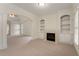 Bright living room boasts a fireplace, built-in shelving and doorway leading to the main bedroom at 6050 Providence Ln, Cumming, GA 30040