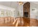 Bright living room featuring a stone fireplace, high ceilings, and views into other rooms at 6050 Providence Ln, Cumming, GA 30040