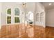 Bright living room showcasing large windows, a fireplace, and gleaming hardwood floors at 6050 Providence Ln, Cumming, GA 30040