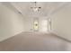 Expansive main bedroom boasts tray ceiling with ceiling fan and doorway to a dressing area at 6050 Providence Ln, Cumming, GA 30040