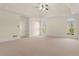 Spacious main bedroom features neutral carpet, natural lighting and tray ceilings at 6050 Providence Ln, Cumming, GA 30040